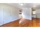 Inviting room with gleaming hardwood floors, fresh white walls, and natural light, perfect for relaxation and comfort at 1013 Graham St, Burlington, NC 27217