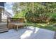 Multi-level deck leads to concrete patio and grassy area, ideal for outdoor activities at 102 Martins Point Pl, Cary, NC 27519