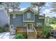 A spacious deck and patio extend from the house into a lush backyard with mature trees at 102 Martins Point Pl, Cary, NC 27519