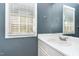 Modern bathroom featuring a white vanity and sink with a view from the window at 102 Martins Point Pl, Cary, NC 27519