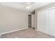 Bedroom with closet, carpet, ceiling fan, and light gray walls at 102 Martins Point Pl, Cary, NC 27519