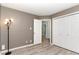 Bedroom with wood-look floors, a ceiling fan, a closet and two doors at 102 Martins Point Pl, Cary, NC 27519