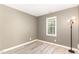 Bright bedroom with modern flooring, natural light, and a modern light fixture at 102 Martins Point Pl, Cary, NC 27519