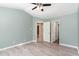 Open bedroom with vaulted ceiling, ceiling fan, and light gray, wood-look floors at 102 Martins Point Pl, Cary, NC 27519