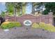 A classic brick community entrance with lush landscaping and a welcoming sign at 102 Martins Point Pl, Cary, NC 27519