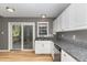 Bright kitchen area featuring stainless steel appliances, granite countertops, and a sliding glass door at 102 Martins Point Pl, Cary, NC 27519