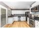 Well-lit kitchen features stainless steel appliances, granite countertops, and a garden window at 102 Martins Point Pl, Cary, NC 27519