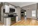 Modern kitchen with stainless steel appliances, granite countertops, and open to living room at 102 Martins Point Pl, Cary, NC 27519