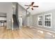 Open-concept living space includes wood floors, stairs, natural light, and neutral wall colors at 102 Martins Point Pl, Cary, NC 27519