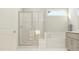 Bright bathroom featuring a tiled shower, tub, and a neutral double vanity at 104 Corapeake Way, Apex, NC 27539