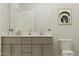 Bathroom featuring a double vanity, modern fixtures, and a separate toilet area at 104 Corapeake Way, Apex, NC 27539
