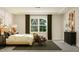 Airy bedroom featuring a wooden bed frame, large window, side table, and a dresser at 104 Corapeake Way, Apex, NC 27539