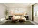 Inviting bedroom with modern decor, two chairs, natural light, and matching nightstands at 104 Corapeake Way, Apex, NC 27539