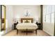 Bright bedroom featuring a natural wood bed frame and eye-catching cactus art on the wall at 104 Corapeake Way, Apex, NC 27539