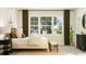 Bright bedroom featuring a natural wood bed frame with large windows at 104 Corapeake Way, Apex, NC 27539