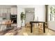 Modern dining area with sleek chairs and table complemented by a contemporary chandelier at 104 Corapeake Way, Apex, NC 27539