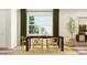 Modern dining area with sleek chairs and table complemented by a contemporary chandelier at 104 Corapeake Way, Apex, NC 27539