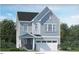 Charming two-story home with stone accents, gray siding, and a bright white garage at 104 Corapeake Way, Apex, NC 27539
