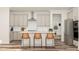 Bright, modern kitchen features a center island, stainless steel appliances, and sleek countertops at 104 Corapeake Way, Apex, NC 27539