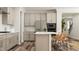 Modern kitchen featuring white cabinets, stainless steel appliances, and a functional island at 104 Corapeake Way, Apex, NC 27539