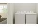 A bright laundry room, with new appliances next to a window, perfect for chores at 104 Corapeake Way, Apex, NC 27539