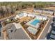 Overhead view of a community with modern townhomes, a pool, a playground, and clubhouse at 104 Vallco Ln, Durham, NC 27713