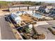 Aerial view of a neighborhood community center with a pool and recreation area amid modern townhomes at 104 Vallco Ln, Durham, NC 27713
