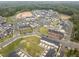 Aerial view of a community with single-Gathering homes, townhomes, and green spaces at 104 Vallco Ln, Durham, NC 27713