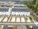 Aerial view of new townhome construction featuring back decks and driveways at 104 Vallco Ln, Durham, NC 27713