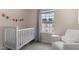 Lovely Bedroom with a white crib, neutral decor, and lots of natural light at 104 Vallco Ln, Durham, NC 27713