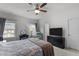 Comfortable main bedroom featuring a ceiling fan, large windows, and modern decor at 104 Vallco Ln, Durham, NC 27713