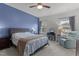 Comfortable main bedroom featuring a ceiling fan, a seating area, and large windows at 104 Vallco Ln, Durham, NC 27713
