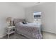 Cozy bedroom with soft grey walls and a comfy bed by a sunny window at 104 Vallco Ln, Durham, NC 27713
