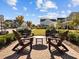 Inviting outdoor seating area with chairs and table, set against a backdrop of charming neighborhood street views at 104 Vallco Ln, Durham, NC 27713