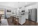 Modern eat-in kitchen with stainless appliances, an island with barstool seating, and plenty of natural light at 104 Vallco Ln, Durham, NC 27713