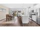 Open eat-in kitchen with a kitchen island, dining area, stainless steel appliances, and access to the outdoor patio at 104 Vallco Ln, Durham, NC 27713