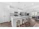 Bright eat-in kitchen featuring quartz countertops, stainless steel appliances, and an open-concept design to the living room at 104 Vallco Ln, Durham, NC 27713