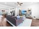 A spacious living room with a comfortable couch, ceiling fan, and entertainment center at 104 Vallco Ln, Durham, NC 27713