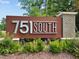 Community sign for 751 South with natural stone, landscaping, and shrubbery at 104 Vallco Ln, Durham, NC 27713
