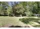 Backyard featuring a grassy area with trees and wooded area at 106 Argyle Ct, Garner, NC 27529