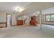 Open basement layout with neutral carpet, bar area, piano, and stairway access at 106 Argyle Ct, Garner, NC 27529