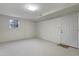 Unfinished basement featuring neutral carpet, a window and door at 106 Argyle Ct, Garner, NC 27529
