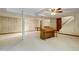 Spacious basement area with neutral carpet, piano, support beams, and access to stairs at 106 Argyle Ct, Garner, NC 27529