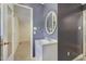Bathroom with white vanity sink, framed mirror, and blue accent wall at 106 Argyle Ct, Garner, NC 27529