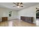 Bright bedroom with laminate flooring, a ceiling fan, and natural light from the window at 106 Argyle Ct, Garner, NC 27529