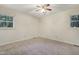 Neutral bedroom with carpeted floors, ceiling fan and natural light from dual windows at 106 Argyle Ct, Garner, NC 27529