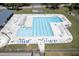 Overhead shot of community pool with fenced exterior, rows of loungers and patio tables at 106 Argyle Ct, Garner, NC 27529
