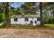 Charming brick home with black shutters, a black front door, and landscaped front yard at 109 Riverbend Dr, Archer Lodge, NC 27527