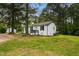 A charming brick home surrounded by trees, with a well-maintained lawn and landscaping at 109 Riverbend Dr, Archer Lodge, NC 27527