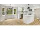 Modern kitchen with white cabinetry, stainless steel appliances, and kitchen island at 109 Riverbend Dr, Archer Lodge, NC 27527